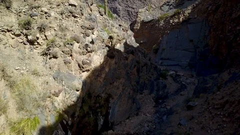 Desert canyon and small stream in mountain environment ASCENDING DRONE SHOT Stock Footage 88484262
