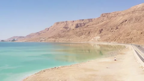 Desert cliffs reflecting into The Dead Sea Stock Footage 154876389