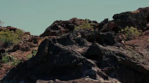 A desert cross rises on a cliff face in Arizona Stock Footage 241498499