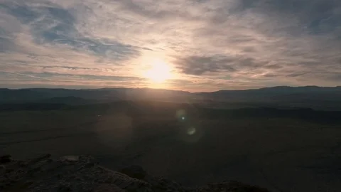 Desert drone flying over cliff into sunset Stock Footage 123003237