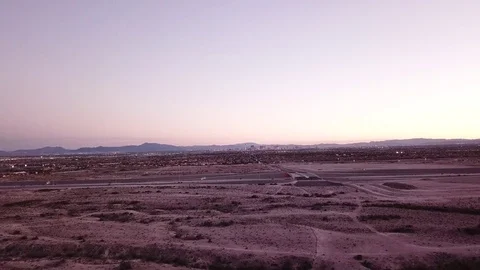 Desert flyover rising shot with Las Vegas far in distance of skyline Stock Footage 81575053