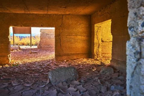 Desert Ghost Town Interior Sunlit Crumbling Walls and Mud Crack Floor Stock Photos