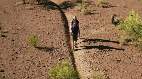 Desert Hikers on Rugged Trail Stock Footage 64534237