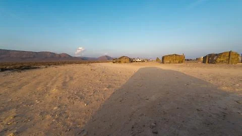 Desert huts with mountains at sunset Stock Photos