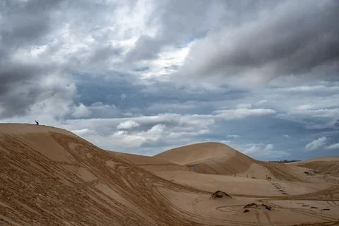 A desert landscape with a cloudy sky Stock Photos