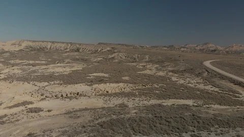 Desert Landscape Fly Over Abandoned House and Red Van at Bardenas Reales  Video stock 103318980