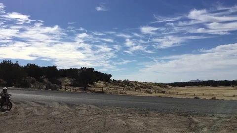 Desert landscape, two different motor cycles cross the view HD Stock-Footage 69760300