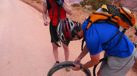 Desert Mountain Biking Flat Tire Repair Stock Footage 25213731