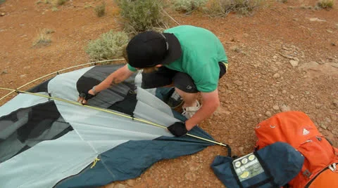 Desert Mountain Biking Rider Setting up Tent in Camp Stock Footage 25207268