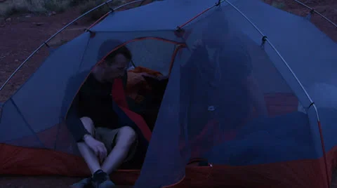 Desert Mountain Biking Riders Inflating Sleeping Mat in Camp Stock Footage 25210288