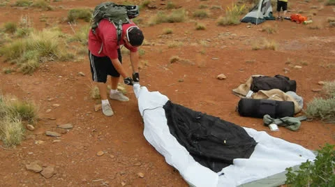 Desert Mountain Biking Setting Up Tent at Camp Video stock 25209650