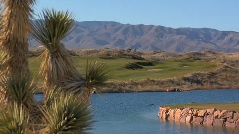 Desert mountains behind golf course and river A Stock Footage 125343856