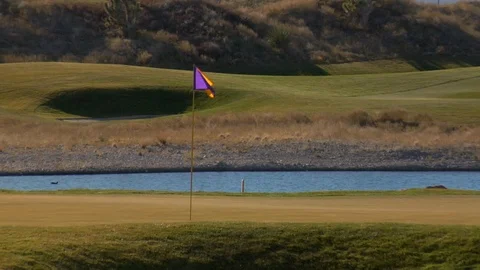 Desert mountains behind golf course and river B Stock Footage 125343879