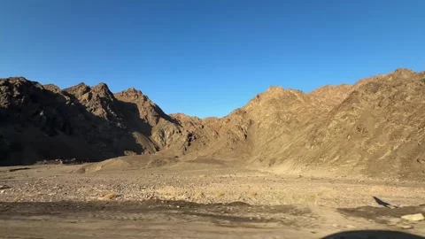 Desert mountains seen from moving car side window and shadow on roadside Stock Footage 341912144
