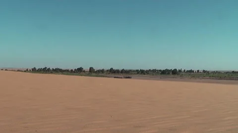 Desert with oasis in background Видео 7734626