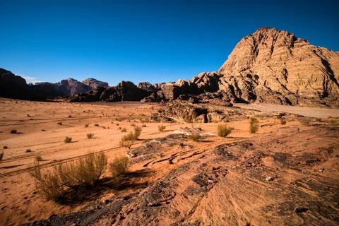 Desert plain and sandstone cliffs in Wadi Rum Stock Photos