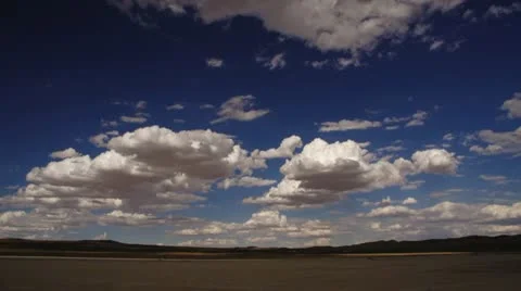 Desert with puffy clouds forming timelapse Stock Footage 18940608