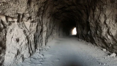 Desert riding recreation enter abandoned railroad tunnel POV 4K Stock Footage 133455599