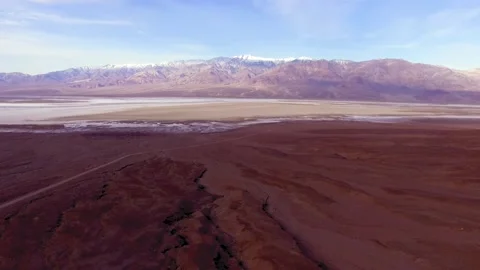 Desert road, Badwater Basin and snowcapped Panamint Range. Death Valley, Ca Stock Footage