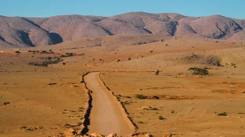 Desert Road Leading to Mountains in Namibia Stock Footage 318648667