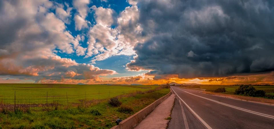 Desert road under a dramatic sky Stock Photos