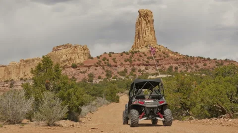 Desert road UTV driving away from camera stone monument - 4K UHD 0209 Stock Footage 49731863