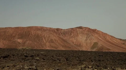Desert of rocks and a mountain Stock Footage 73664788