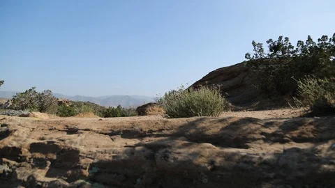 Desert Rocks with mountains in BG Video stock 90072458
