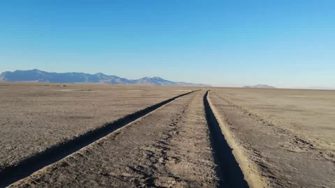 Desert Salt Flats with Tractor Tracks in Low Flying Aerial View Stock Footage 142299805