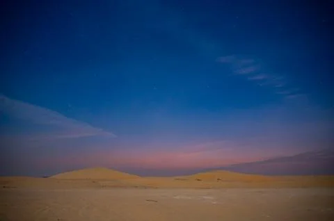 Desert sand dune with beautiful clouds. Stock Photos