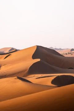 Desert sand dunes creating wavy patterns in oman Stock Photos