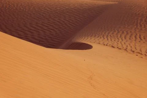Desert Sand Dunes with Wavy Patterns in Oman Stock Photos
