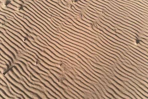 Desert sand texture with line pattern, top view Stock Photos
