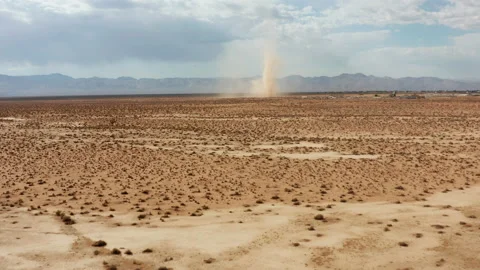 A desert sandstorm kicks up a dust devil in the Mojave Desert landscape - Video stock 155136689