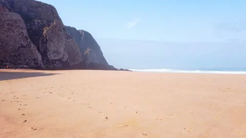 Desert sandy beach in a summer day with a cliff in background Stock Footage 140223461