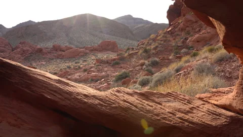 A desert scene viewed through a red rock arch. Stock Footage 155706877