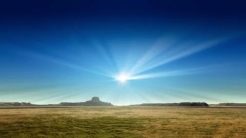 A desert scenery with sun rays in the blue sky Stock Illustration