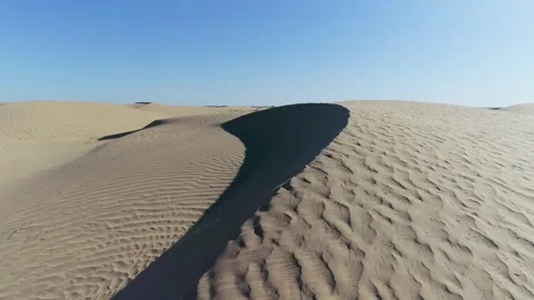 Desert in the spring. Dunes with rare grass. Filmed by drone Stock Footage 198643702