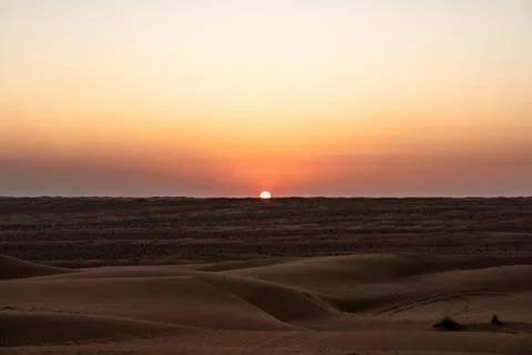 Desert sunset over rolling sand dunes in oman Stock Photos