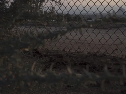 Desert Sunset Timelapse Through Chain Fence Stock Footage 161902178