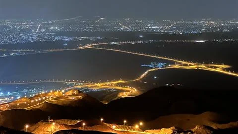 Desert transforms into network of illuminated roads at night, resembling Stock Photos