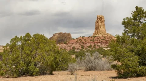 Desert wind blowing juniper trees rock tower cloudy - 4K UHD 0204 Stock Footage 49730341