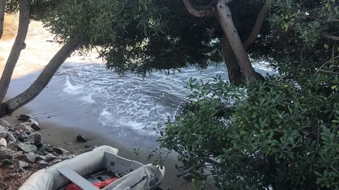 Deserted beach with dinghy Stock Footage 98802532