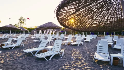 Deserted beach, empty beach chairs, sun rays, Turkish flag Stock Footage 307789611