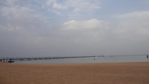 Deserted beach before sunset in Sharm El Sheikh. Two People Are Walking On Water Stock Footage 117094947