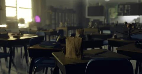Deserted classroom with empty desks and personal belongings scattered around Stock Illustration