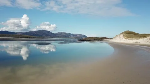 Deserted endless beach, Relected sky on still water. Low level Stock Footage 136743667