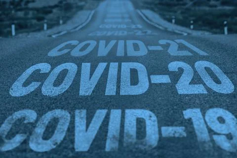 Deserted highway with the text COVID-19, COVID-20, COVID-21 and so on. The Stock Photos