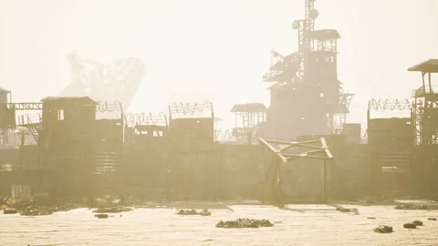 Deserted industrial area under bright sunlight with structures and obstacles Stock Footage 331422420