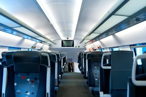 The deserted interior of a high-speed train. Rows of empty seats Stock Photos